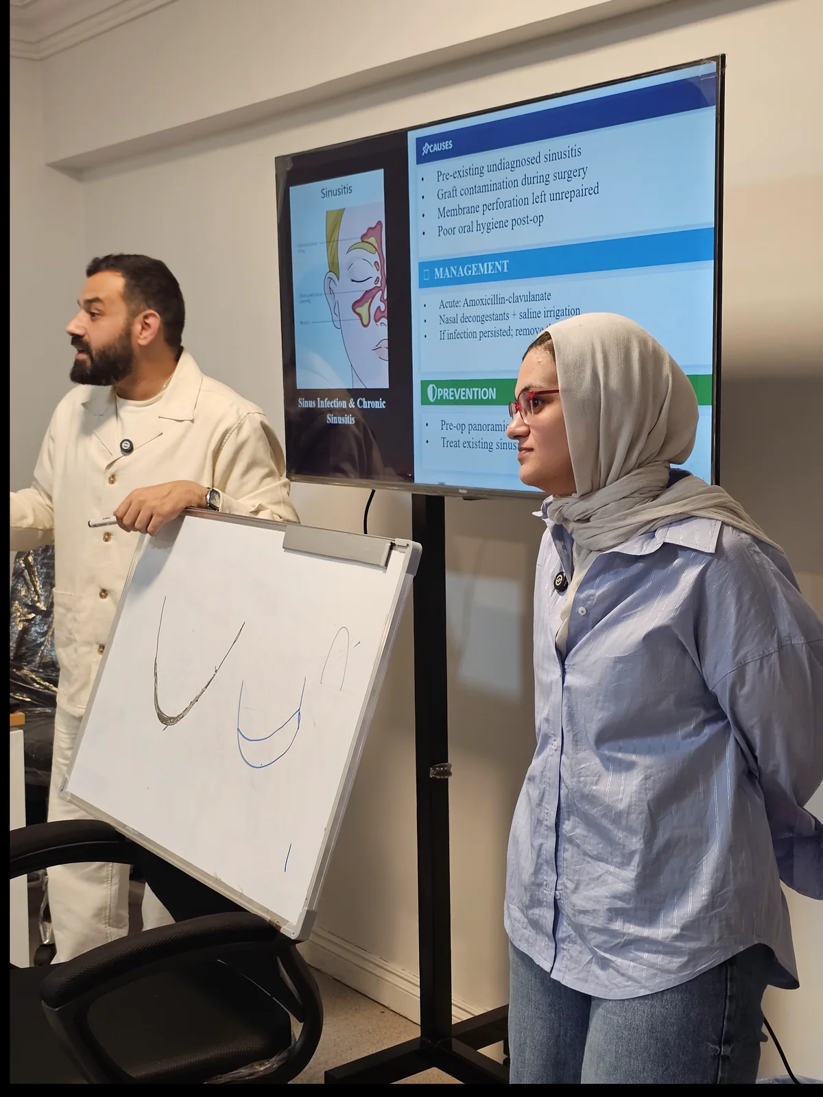 Instructor explaining implant concepts during a teaching session